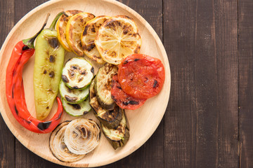 Organic grilled vegetables with pappers on wooden background