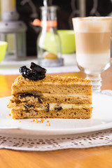 Piece of cake with cream, prunes 