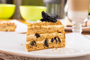 Piece of cake with cream, prunes 