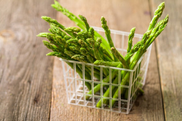 Green fresh asparagus in a plastic basket