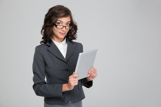 Young business woman in glases using tablet