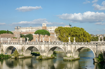 Obraz premium Historic Landmark architecture Eliyev build a bridge to the Castel Sant'Angelo in Rome, on the banks of the Tiber River near the arched bridge across the river on a bright sunny day