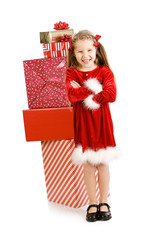 Christmas: Laughing Girl Standing In Front Of Stack Of Gifts