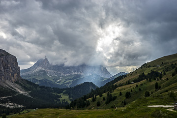 Fototapeta premium Sassolungo (Langkofel) under the clouds with a ray of light on G