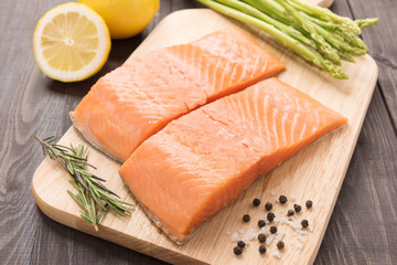 Fresh salmon fillet with spice on wooden table