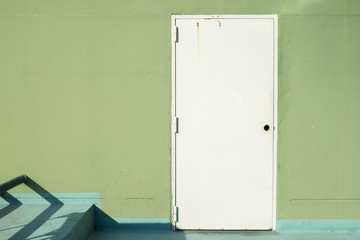 white door on green wall