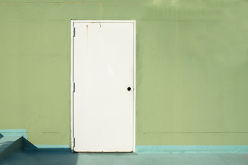 Fototapeta premium white door on green wall