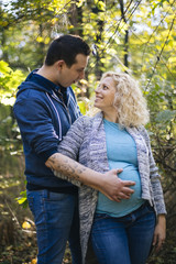 Fototapeta premium Young pregnant couple in the park