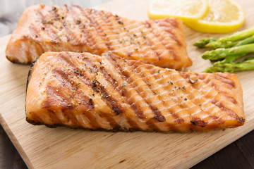 Grilled salmon and lemon, asparagus, on the wooden table