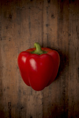 Red pepper on a rustic wood background