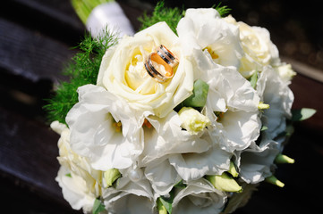 wedding rings on a wedding bouquet