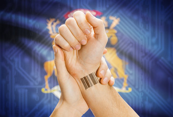 Barcode ID number on wrist and USA states flags on background - Michigan
