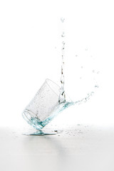 Water splashing from glass isolated on white background
