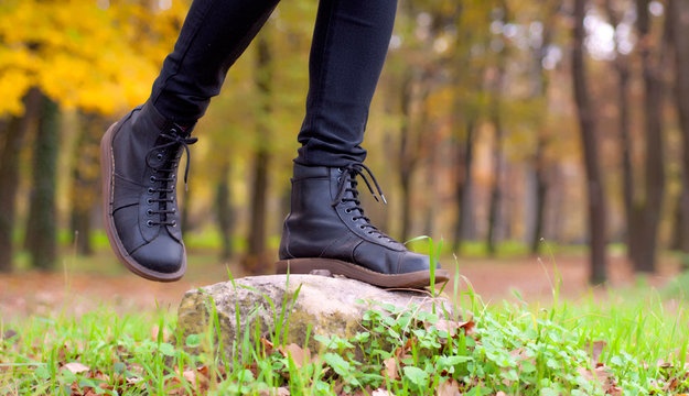 Girl in leather boots in the forest