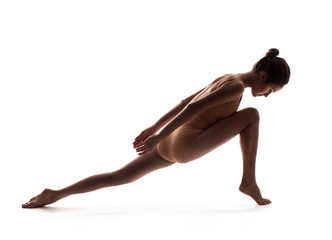 young beautiful dancer in beige swimsuit posing