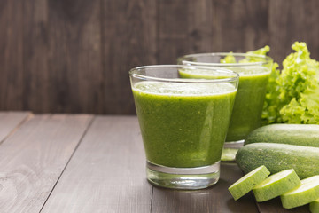 Healthy green vegetables smoothie on rustic wood table
