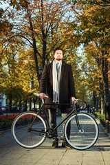 young caucasian businessman with bicycle