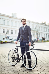 young caucasian businessman with bicycle