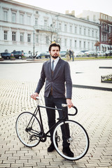 young caucasian businessman with bicycle