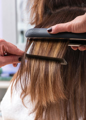 Hairdresser using a hair straightener