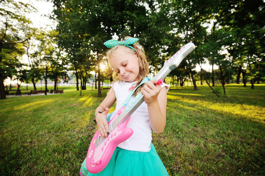 baby girl with a toy guitar