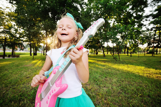 baby girl with a toy guitar