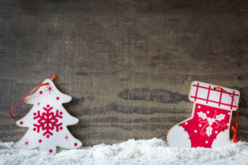 Christmas tree and Christmas sock on snow and wood background