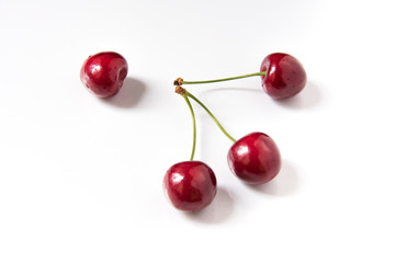 Obraz na płótnie Canvas Bowl of red fresh cerries on a white background
