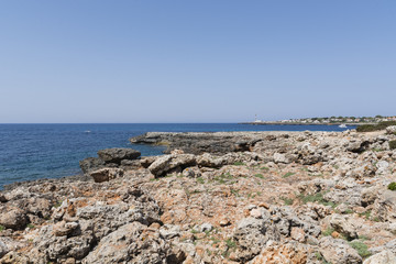 Fototapeta na wymiar View of the rocky coast in Menorca in a summer day with blue sky and blue water, Menorca, Balearic Islands, Spain