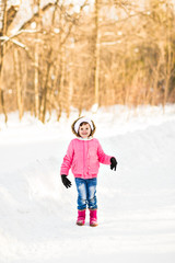 Fototapeta na wymiar Happy baby girl in a winter park
