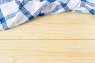 White and blue napkin on wooden table