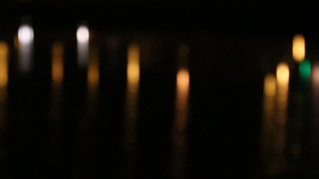 City light bokeh background with water reflection
