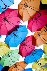 Fototapeta na wymiar Many colorful umbrellas against the sky in city settings. Kosice, Slovakia. Color background