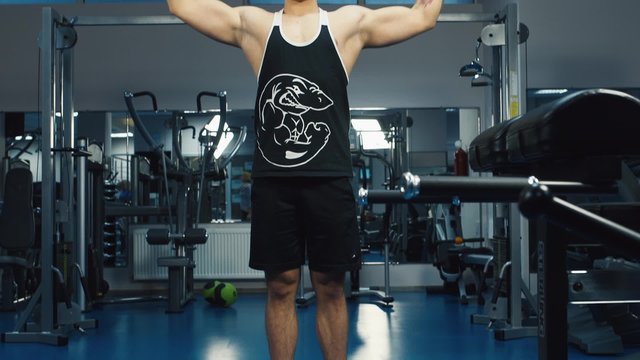 The man trains the biceps muscle on the block device