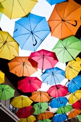 Many colorful umbrellas against the sky in city settings. Kosice, Slovakia. Color background