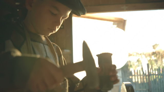 Young hand working in wood chisel carpenter tool hammer