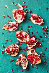 Overhead view of broken pomegranate fruit on table