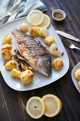 fried dorado fish with mushrooms, lemon and potatoes