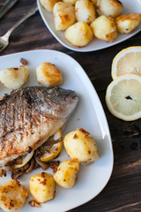 fried dorado fish with mushrooms, lemon and potatoes