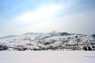 Beautiful, idyllic snowy winter landscape in the mountains, on a crisp sunny morning  hills and slopes  nature.