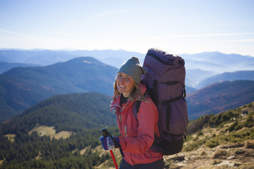 A woman goes to the top of the mountain.