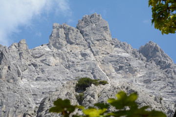 View through branches on rocky alpine peak