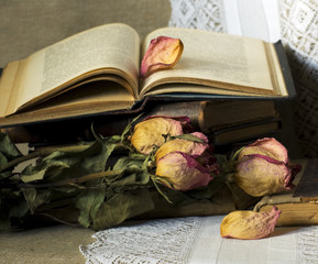 Still life with old books and dried roses