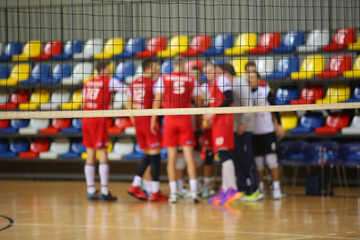 Volleyball players at tne background of volleyball net