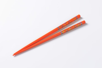 Orange chopsticks with flower pattern