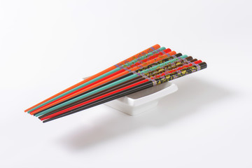 Set of ornate chopsticks on small rectangle bowl