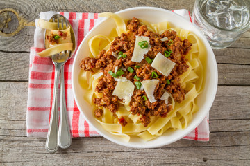 Spaghetti bolognese with salad and tomatoes