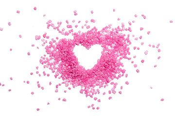 Heart shape from pink candies on white background