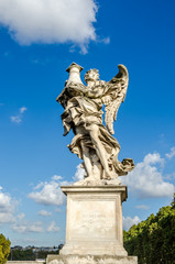 Fototapeta na wymiar Stone statues of angels and apostles Eliyev on the bridge over the River Tiber leading to Castel Sant'Angelo in Rome, capital of Italy near the Vatican