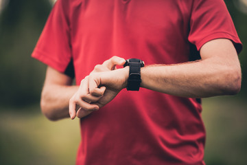 Runner training and using stopwatch with heart rate monitor